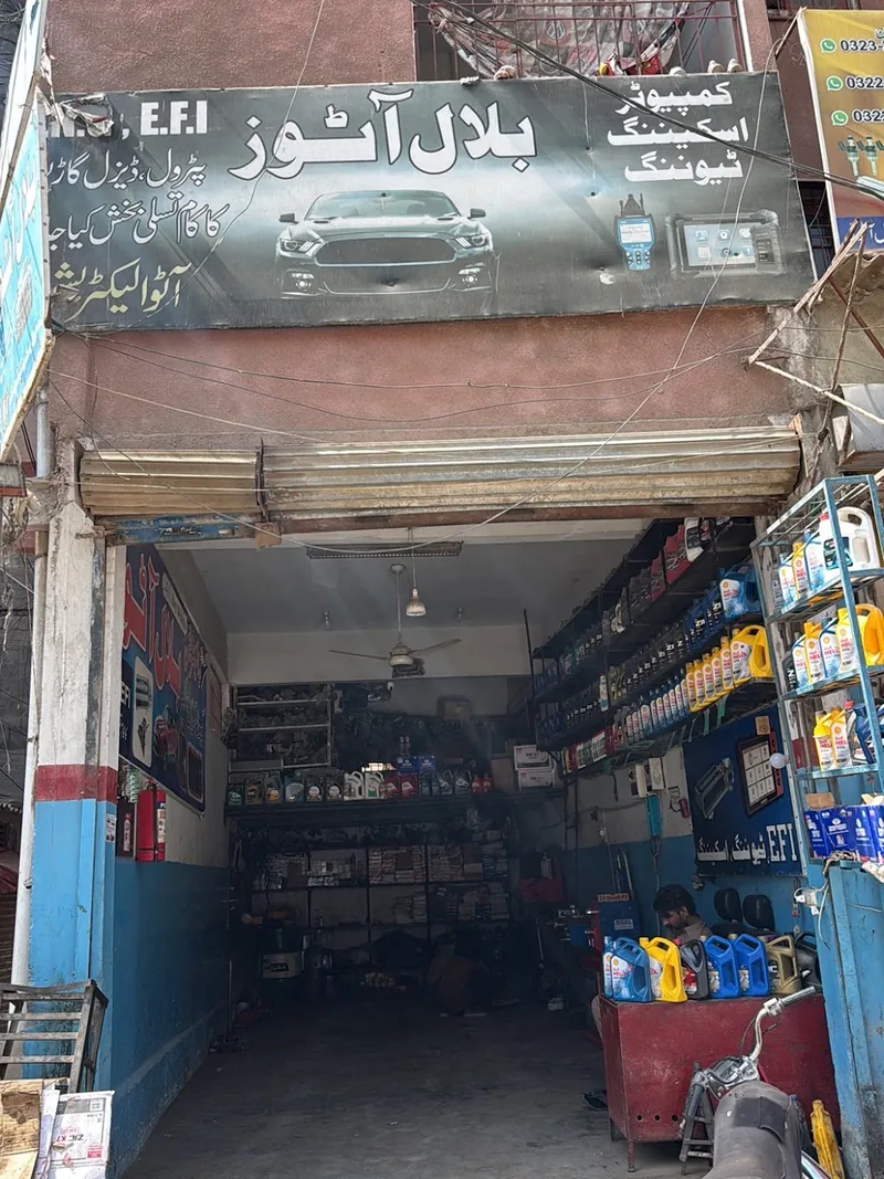 The open workshop bay with oil and parts shelves